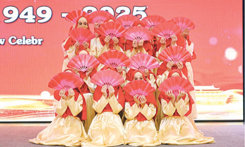 Girls perform a traditional dance at a function hosted  by Chinese cultural centre in Peshawar on Wednesday to mark the 76th Founding Day of People&rsquo;s Republic of China. &mdash; APP