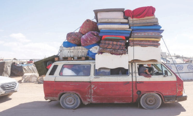 FAMILIES, with their belongings stacked on top of a van, arrive on a coastal path northwest of Nuseirat refugee camp as they are displaced southward from Wadi Gaza, following the Israeli announcement of closing a key road towards the north of the besieged Gaza Strip.&mdash;AFP
