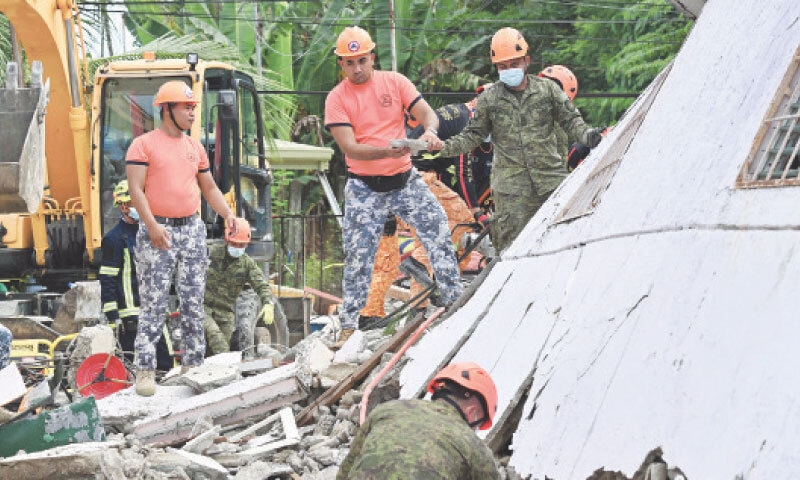 RESCUERS clear rubble during search and rescue operations in Bogo City, central Philippines.&mdash;AFP