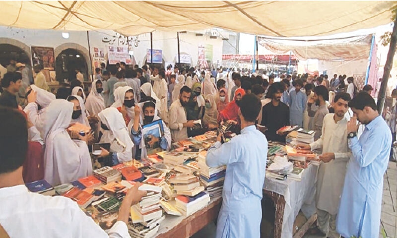 Students take a keen interest in books on display at the cultural festival.—Dawn Students take a keen interest in books on display at the cultural festival.—Dawn