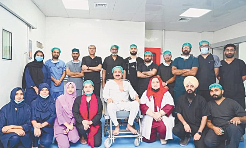 SAHIWAL: Patient along with the medical team at the Sahiwal Institute of Cardiology. &mdash; Dawn