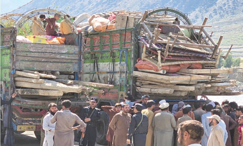 Trucks loaded with household items of repatriating Afghans at Kesu Khairabad camp, Lower Chitral. &mdash; Dawn