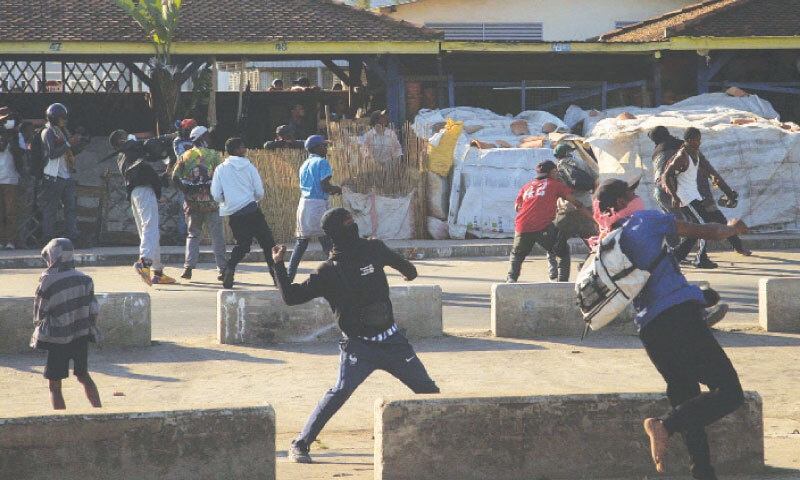 PROTESTERS hurl stones at security personnel during a youth-led demonstration in Antananarivo over frequent power outages and water shortages.&mdash;Reuters
