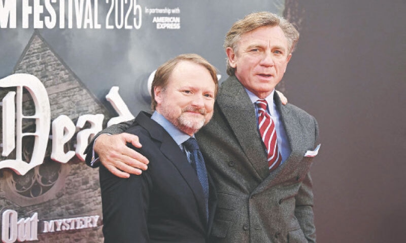 US DIRECTOR Rian Johnson and British actor Daniel Craig (right) pose on the red carpet upon arrival at the London Film Festival.&mdash;AFP