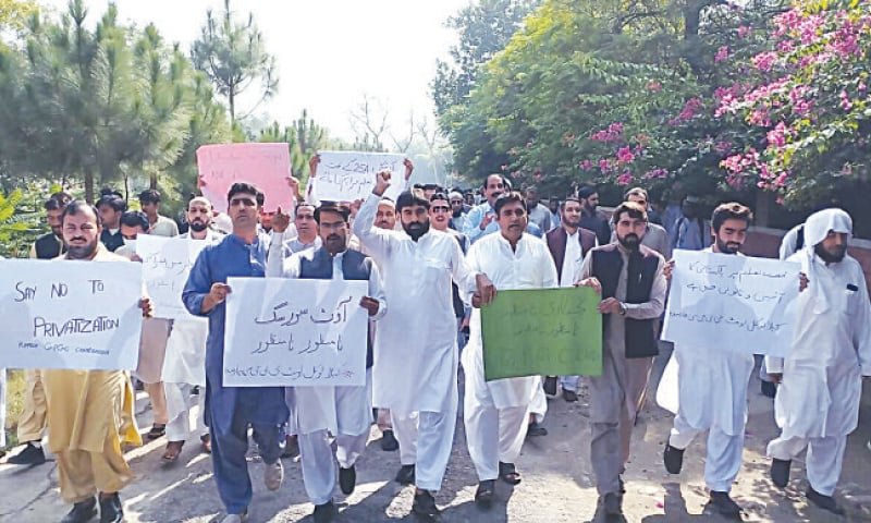 Teachers of different colleges stage a protest in Charsadda on Thursday. &mdash; Dawn