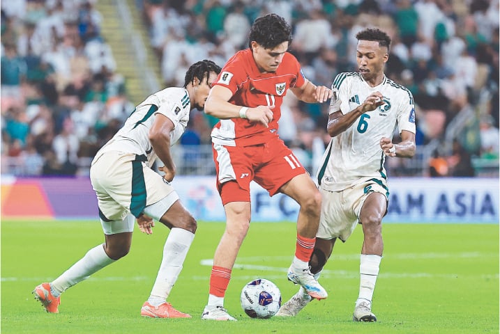 JEDDAH: Indonesia&rsquo;s Ragnar Oratmangoen (C) vies for the ball with Nasser Al-Dawsari of Saudi Arabia (R) during their World Cup qualifier at the King Abdullah Sports City.&mdash;Reuters