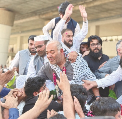 RECENTLY freed by Israel, ex-senator Mushtaq Ahmad Khan receives a hero’s welcome upon his return at Islamabad airport.—White Star