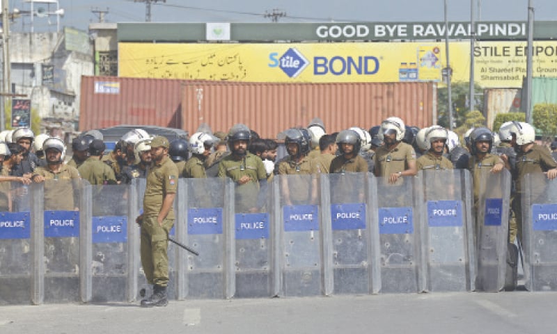 Police personnel stand alert at Faizabad in Rawalpindi on Friday. &mdash; White Star