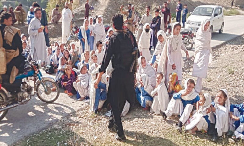 Students block a road in Mohmand on Tuesday. &mdash; Dawn