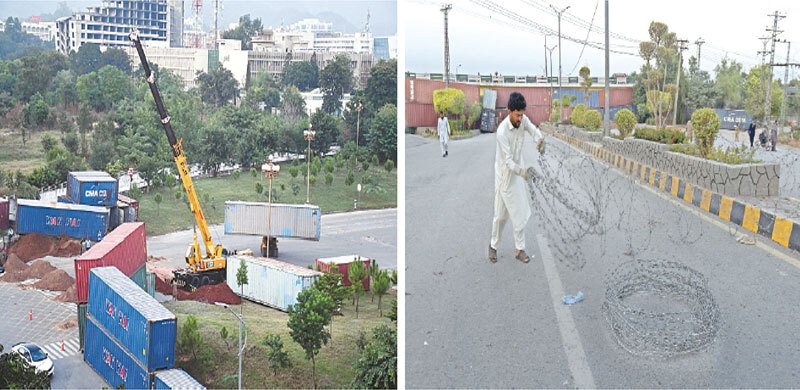  A crane is being used to lift containers from D-Chowk in Islamabad while an official of the capital administration removes barbed wires from Faizabad after fears of further TLP protests subsided on Tuesday. &mdash; Photos by Mohammad Asim 