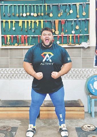 WEIGHTLIFTER Nooh Dastagir Butt poses in front of his medals. 