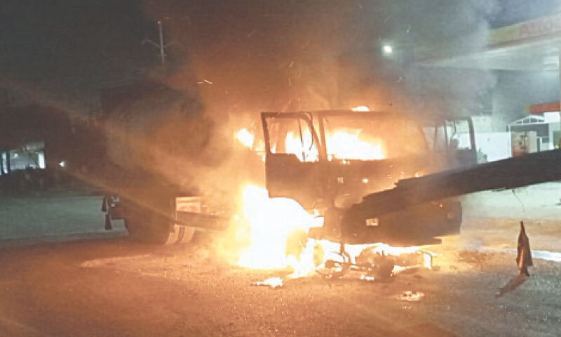 Angered residents set one of the heavy vehicles on fire, police say. — Dawn Angered residents set one of the heavy vehicles on fire, police say. — Dawn