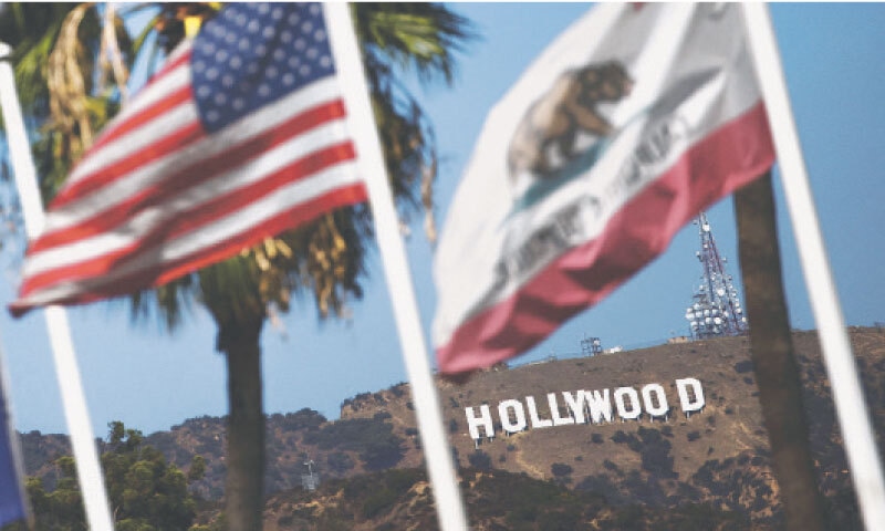 Flags flutter in front of the Hollywood sign in Los Angeles, California.—Reuters Flags flutter in front of the Hollywood sign in Los Angeles, California.—Reuters