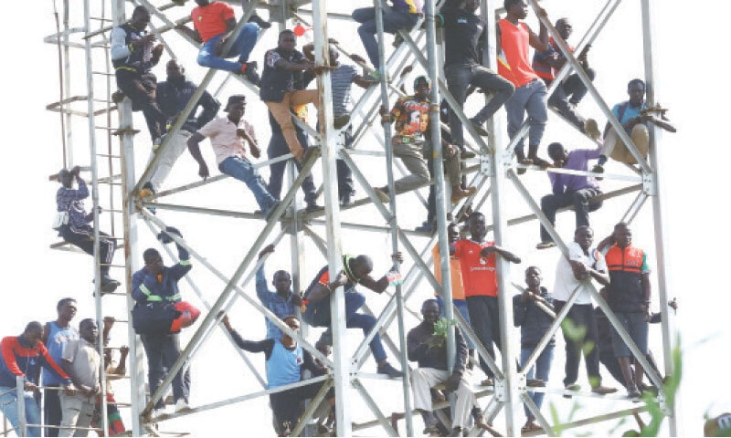 Mourners stand on a tower during the funeral service for Kenyan opposition leader Raila Odinga at the Jomo Kenyatta Stadium in Mamboleo.—Reuters Mourners stand on a tower during the funeral service for Kenyan opposition leader Raila Odinga at the Jomo Kenyatta Stadium in Mamboleo.—Reuters