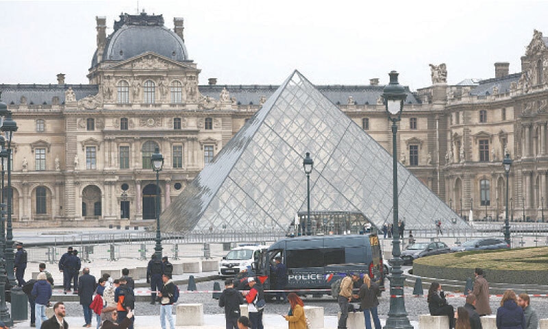 Law enforcement personnel gather around the Louvre museum after reports of a robbery.&mdash; Reuters
