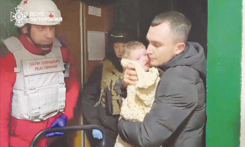 EMERGENCY workers evacuate residents from the site of a Russian strike near Zaporizhzhia.&mdash;Reuters