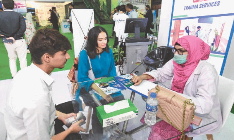 People visit different stalls at the Health Asia Exhibition at Karachi Expo Centre.&mdash;INP