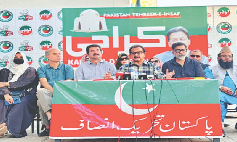 PTI leader Haleem Adil Sheikh speaks, alongside others, at the press conference.&mdash;Dawn