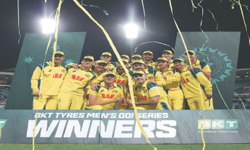SYDNEY: Australia players celebrate with the trophy after winning the One-day International series against India at the Sydney Cricket Ground on Saturday.&mdash;Reuters