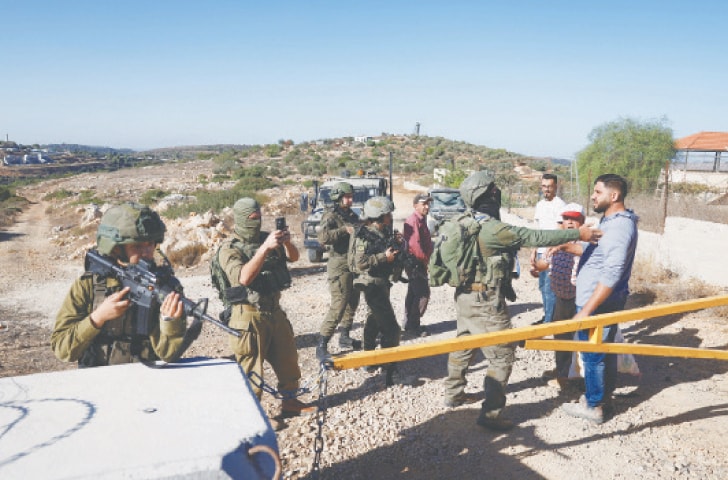 Israeli forces hinder Palestinians&rsquo; access during olive harvest at a village in Israeli-occupied West Bank.&mdash;Reuters