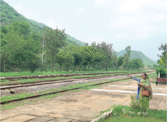 Tourists stand on the platform of Tarraki railway station.