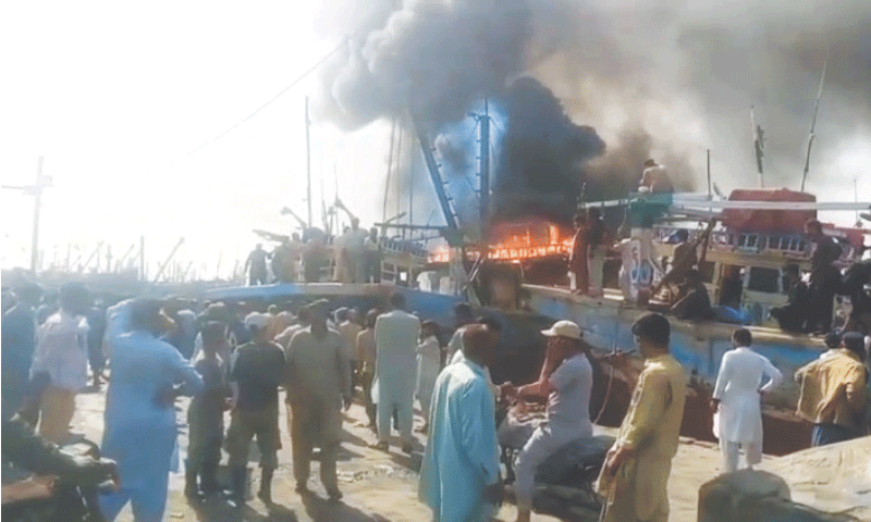 A cloud of smoke billows out of the boats in the Fisheries area.&mdash;Shakil Adil / White Star