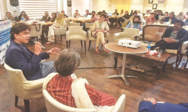 Shehzad Roy speaks at the event as Education Minister Sardar Shah and others look on.&mdash;Fahim Siddiqi / White Star