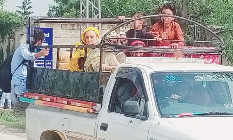 A family leaves Khar’s rural area in a pick-up van on Tuesday. — Dawn A family leaves Khar’s rural area in a pick-up van on Tuesday. — Dawn