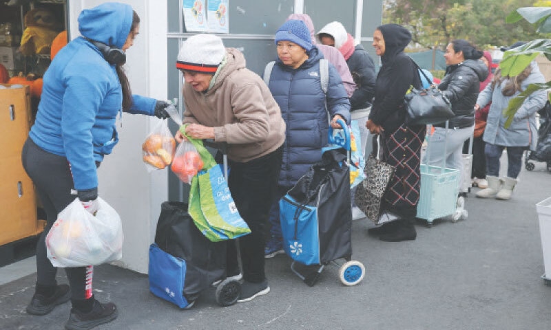 CHELSEA (United States): Workers distribute groceries at a pantry ahead of a proposed suspension of food aid benefits from Nov 1 due to the ongoing government shutdown.&mdash;Reuters