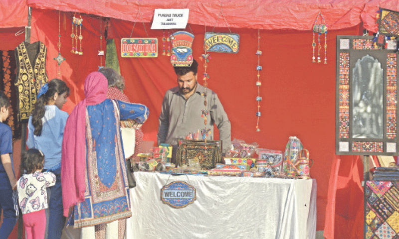 Visitors watch truck art at F-9 Park during Islamabad Sheher Mela, which is celebrating the 65th Anniversary of Islamabad&rsquo;s Master Plan in connection with World Cities Day on Thursday. &mdash; Photo by Mohammad Asim