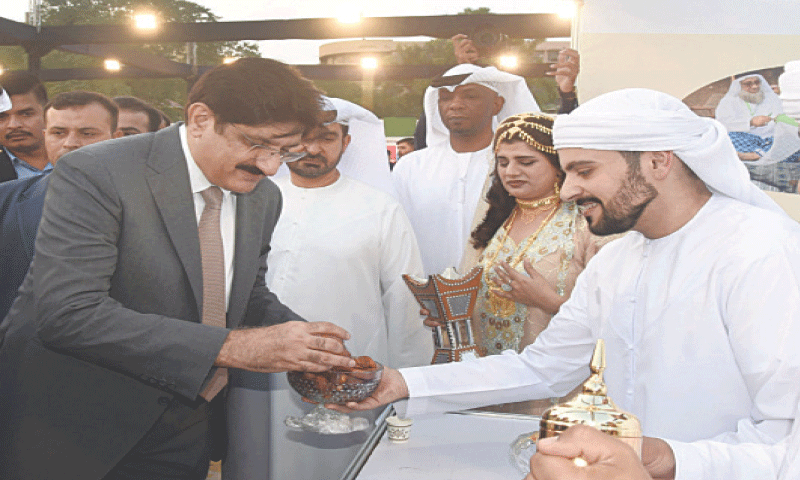 Chief Minister Murad Ali Shah samples the wares at one of the food stalls.—Dawn Chief Minister Murad Ali Shah samples the wares at one of the food stalls.—Dawn