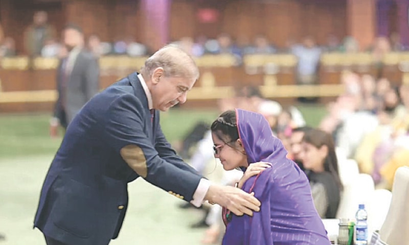 PM Shehbaz Sharif congratulates a student at the Youth Laptop Scheme distribution ceremony.—White Star PM Shehbaz Sharif congratulates a student at the Youth Laptop Scheme distribution ceremony.—White Star