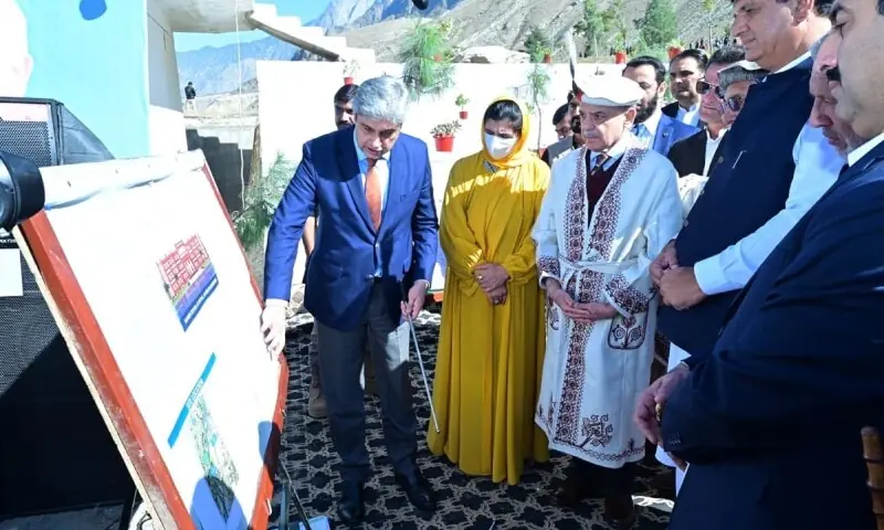 Clad in traditional Chitrali attire, PM Shehbaz Sharif is briefed on the Daanish school project during a ceremony.&mdash;PPI