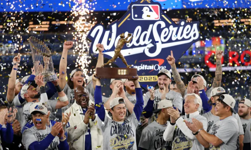 Yoshinobu Yamamoto #18 of the Los Angeles Dodgers raises the Willie Mays World Series Most Valuable Player Award after defeating the Toronto Blue Jays 5-4 in game seven of the 2025 World Series at Rogers Center on November 02, 2025 in Toronto, Ontario. &mdash; AFP