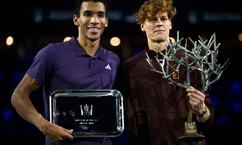 Italy&rsquo;s Jannik Sinner (R) poses with the trophy after winning against Canada&rsquo;s Felix Auger-Aliassime (L) at the end of the men&rsquo;s singles final match of the Paris ATP Masters 1000 tennis tournament at the Paris La D&eacute;fense Arena in Nanterre, on the outskirts of Paris, on November 2, 2025. &mdash; AFP