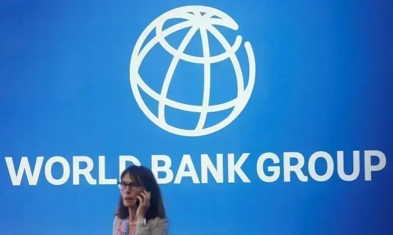 A participant stands near a logo of World Bank at the International Monetary Fund - World Bank Annual Meeting 2018 in Nusa Dua, Bali, Indonesia, October 12, 2018. &mdash; Reuters/File