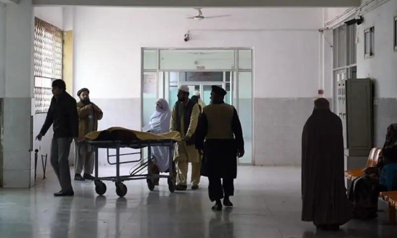 In this file photo,  relatives tend to a man treated at a hospital in Peshawar on December 26, 2015. &mdash; AFP