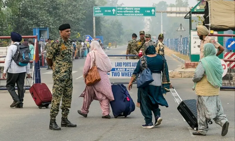  Indian Border Security Force (BSF) personnel stand guard as Indian Sikh pilgrims head to Pakistan at the India-Pakistan Wagah border in Wagah on November 4, 2025, on the eve of celebrations marking the birth anniversary of Guru Nanak, founder of Sikhism. &mdash; AFP/ Narinder Nanu 