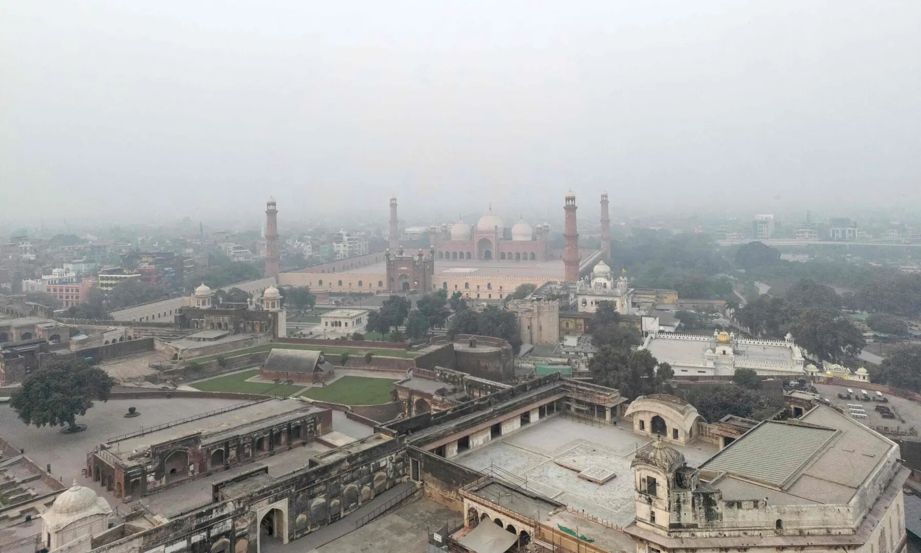An aerial view shows the Badshahi Mosque engulfed in dense smog in Lahore on November 4, 2025. &mdash; AFP
