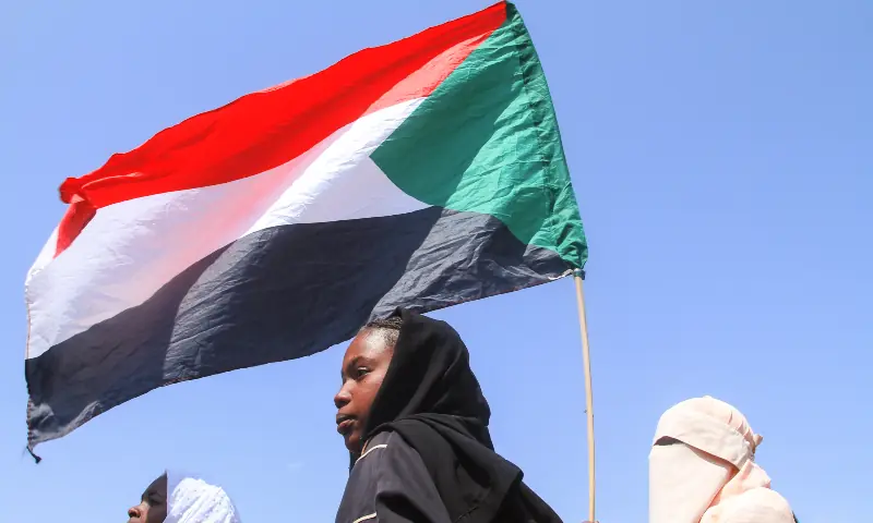 Sudanese Students from schools in the East Nile region of the capital, hold up the Sudan flag, during a protest against violations committed by the Rapid Support Forces (RSF) against the people of El-Fasher, in Khartoum on November 3, 2025. &mdash; AFP