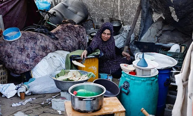 A Palestinian prepares food, amid a ceasefire between Israel and Hamas, in Jabalia, the northern Gaza Strip on November 6. &mdash; Reuters