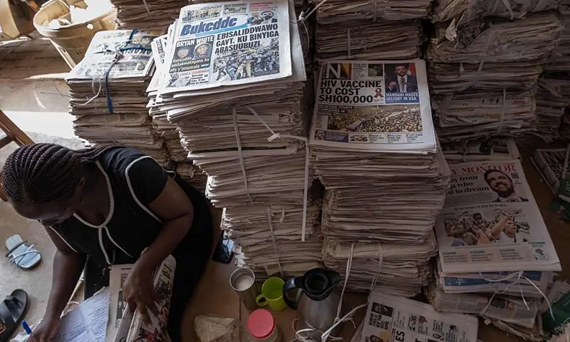 A vendor records sales while selling newspapers carrying headlines about Zohran Mamdani’s electoral victory, the Uganda-born mayor-elect of New York City, in Kampala, Uganda on November 6. — AFP