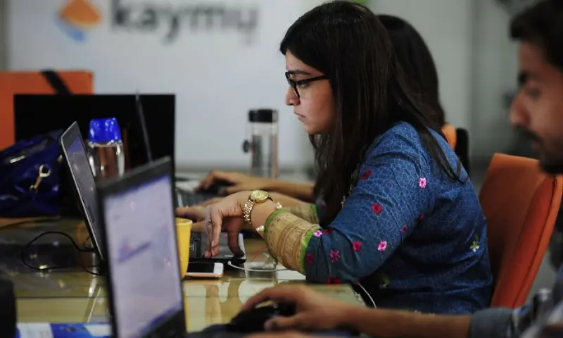This photograph taken on November 19, 2015 shows Pakistani employees of online marketplace company Kaymu at work in Karachi. &mdash; AFP/File
