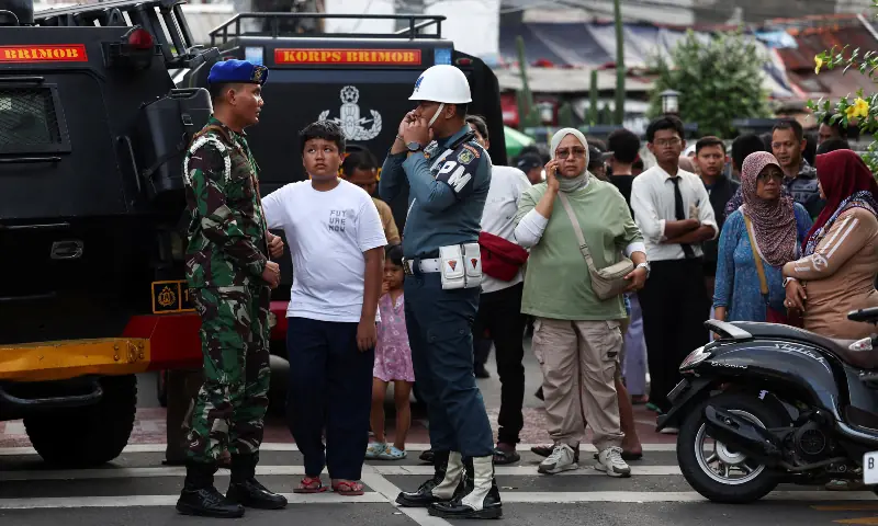 Indonesian military personnel guard as residents gather near the area after an explosion occurred at a school complex in Jakarta, Indonesia on November 7, 2025. &mdash; Reuters