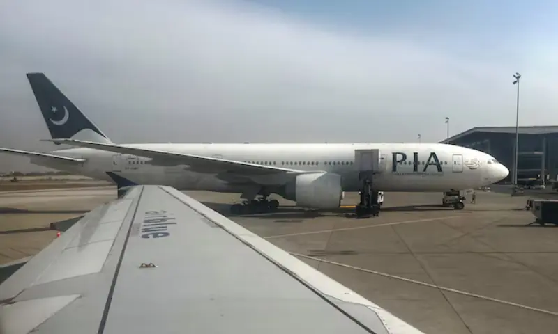 Pakistan International Airlines passenger plane sits on tarmac, as seen through a plane window, at the Islamabad International Airport on October 27, 2024. &mdash; Reuters