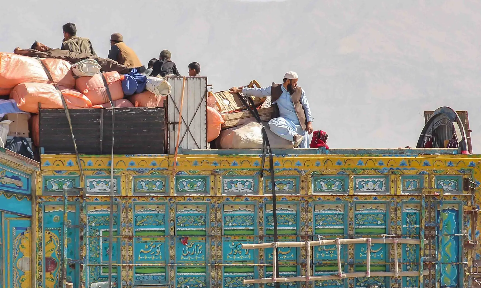 An Afghan refugee family, along with their belongings, sits on a truck as they await deportation to Afghanistan near the Pakistan-Afghanistan border in Chaman on November 7, 2025. &mdash; AFP