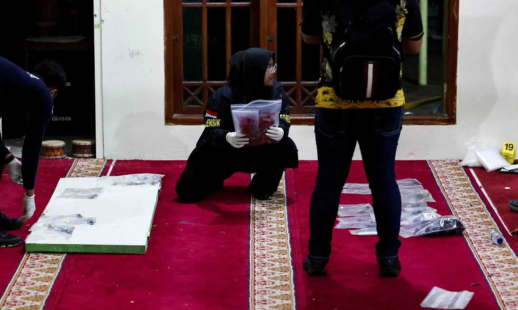 Forensic police officers collect evidence at the area after an explosion occurred at a mosque inside a school complex in Jakarta, Indonesia, November 7, 2025. &mdash; Reuters