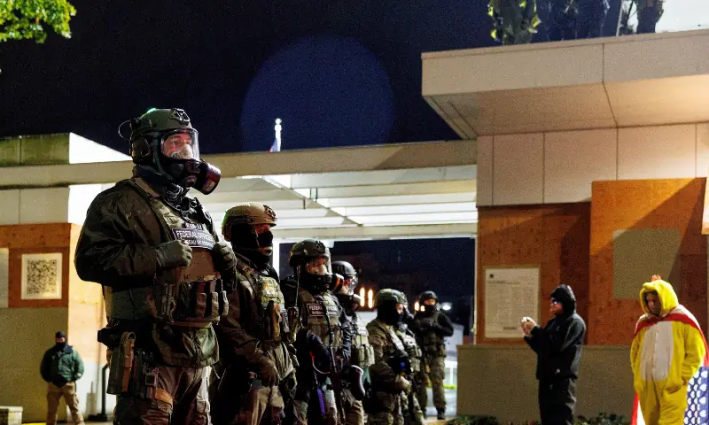 Federal officers stand guard outside the Immigration and Customs Enforcement (ICE) facility as protests and counter-protests continue in Portland, Oregon, US on October 25, 2025. &mdash; Reuters