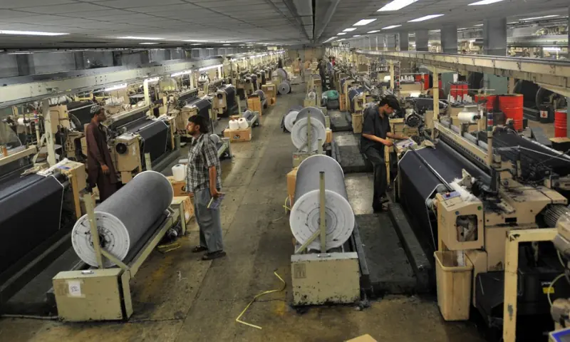 This file photo shows workers at a factory. &mdash; AFP/File
