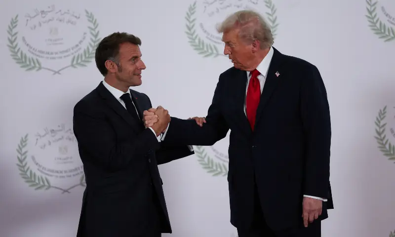 US President Donald Trump and French President Emmanuel Macron shake hands as they pose for a photo, at a world leaders&rsquo; summit on ending the Gaza conflict in Sharm el-Sheikh, Egypt on October 13, 2025. &mdash; Reuters